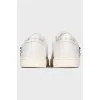 White sneakers with heart-shaped décor