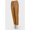 Classic trousers with creases and metal brooch