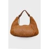 Bag with perforation and tassel