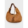 Bag with perforation and tassel