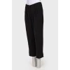 Black pleated cropped trousers