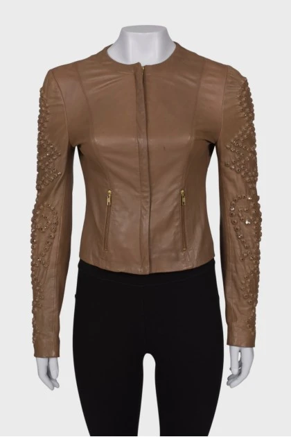 Leather jacket with rhinestones on the sleeves