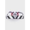 Black and white flip flops with tag
