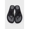 Black flip flops with tag