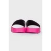 Pink flip flops with brand logo and tag