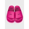 Pink flip flops with brand logo and tag