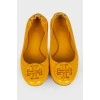 Yellow ballet flats with brand logo
