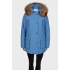Blue parka with fur on the hood with a tag