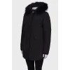 Black parka with fur on the hood with a tag