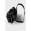 Lacquer choker in the shape of a rose with a tag