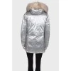 Silver parka with fur on the hood with a tag