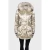 Golden parka with fur on the hood with a tag