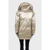 Golden parka with fur on the hood with a tag