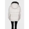 Cropped white down jacket, with a tag