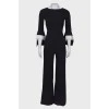 Black jumpsuit close-fitting in the waist