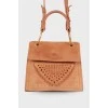 Perforated suede bag