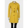 Yellow trench coat at the waist
