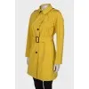 Yellow trench coat at the waist