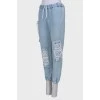Ripped-effect elasticated jeans