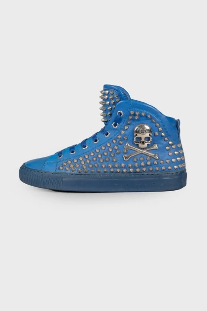 Blue sneakers decorated with spikes