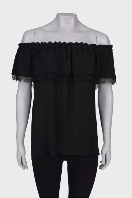 Black top with a frill on the chest