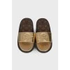 Golden slippers with brand logo