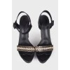 Black sandals with gold trim