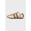 Gold sneakers with brand logo