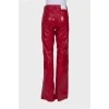 Red embossed trousers with tag