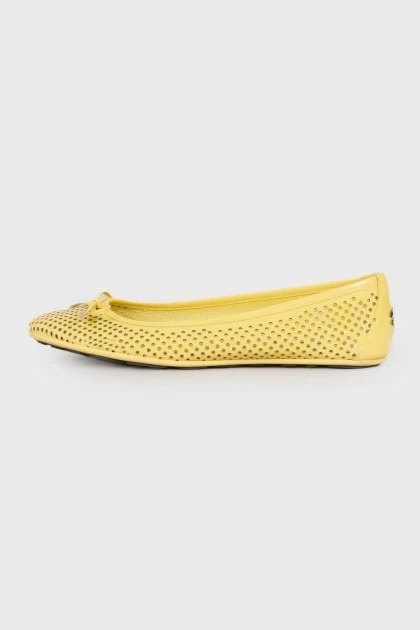 Yellow perforated ballerina shoes