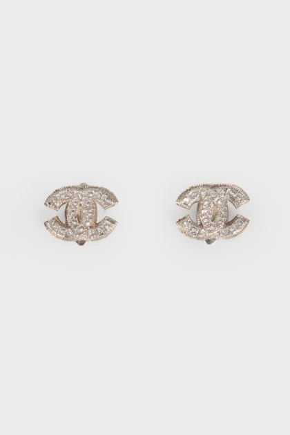 Silver earrings in the shape of the brand logo