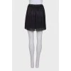 Pleated mini skirt with tag