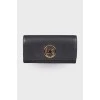 Black wallet with gold brand logo