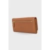 Brown leather wallet with brand logo
