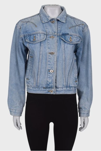 Denim jacket with a pattern on the back
