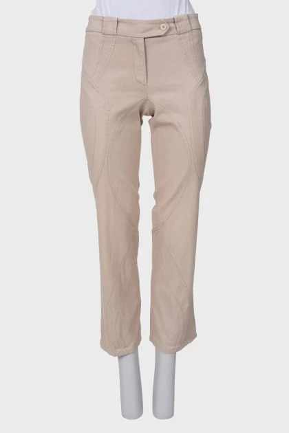 Beige pants with asymmetrical seams