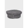 Cap in houndstooth print with tag