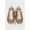 Golden sneakers decorated with rhinestones