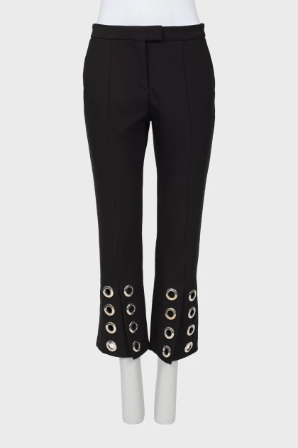 Trousers with metal fittings