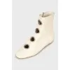 White boots with decorated perforations