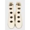 White boots with decorated perforations