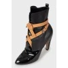 Black leather ankle boots decorated with ties