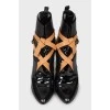 Black leather ankle boots decorated with ties