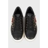 Black leather sneakers with decor