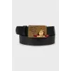 Men's leather belt with a pattern on the buckle