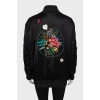 Black bomber jacket decorated with flowers