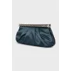 Satin clutch decorated with chain