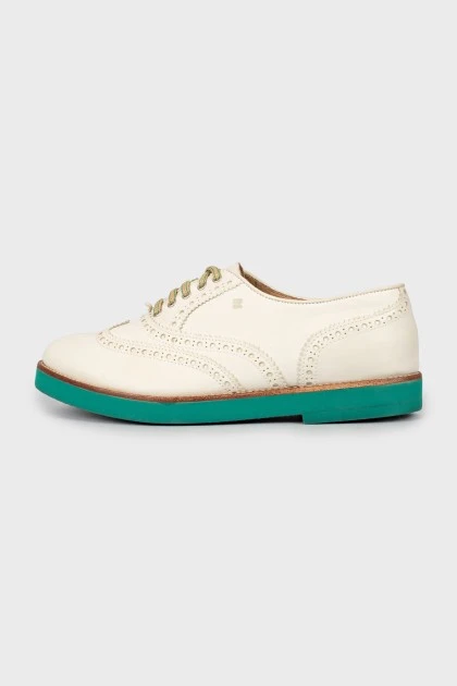 Leather brogues with green sole