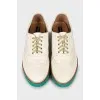Leather brogues with green sole