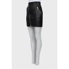 Leather mini skirt with oblique zipper